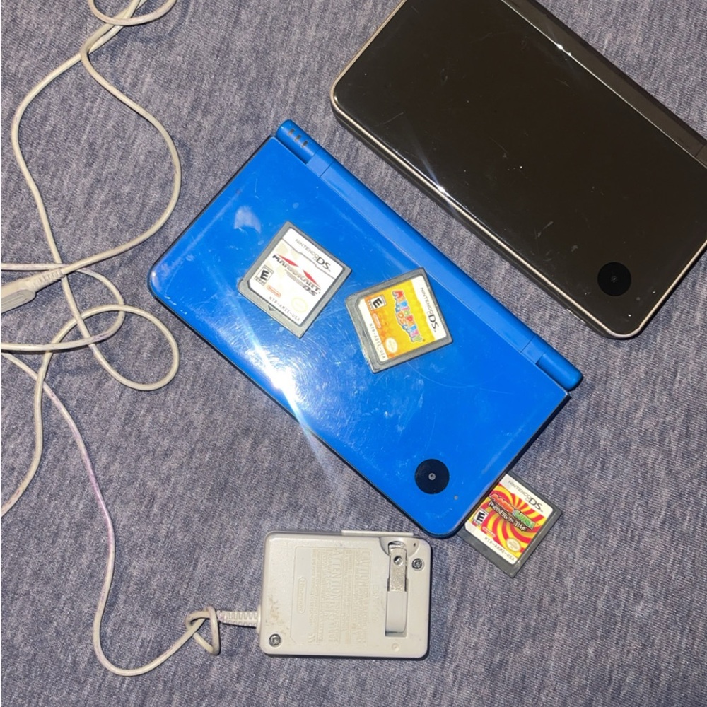 Blue and Black Nintendo DS Consoles with Games